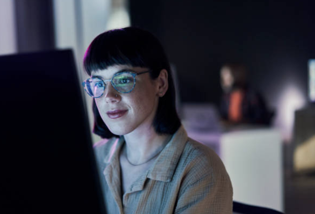 Woman looking at AI on a computer screen